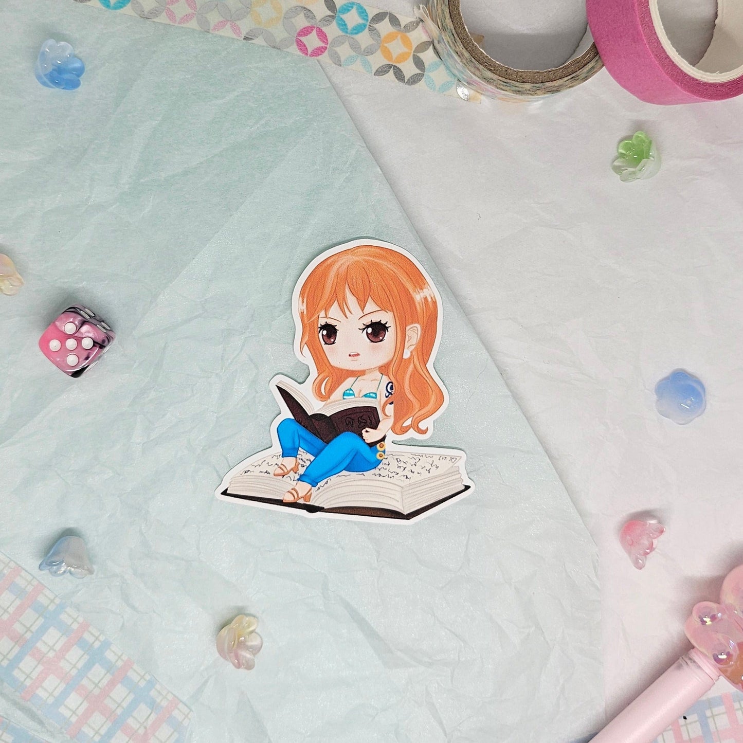 Sticker of Nami from One Piece reading