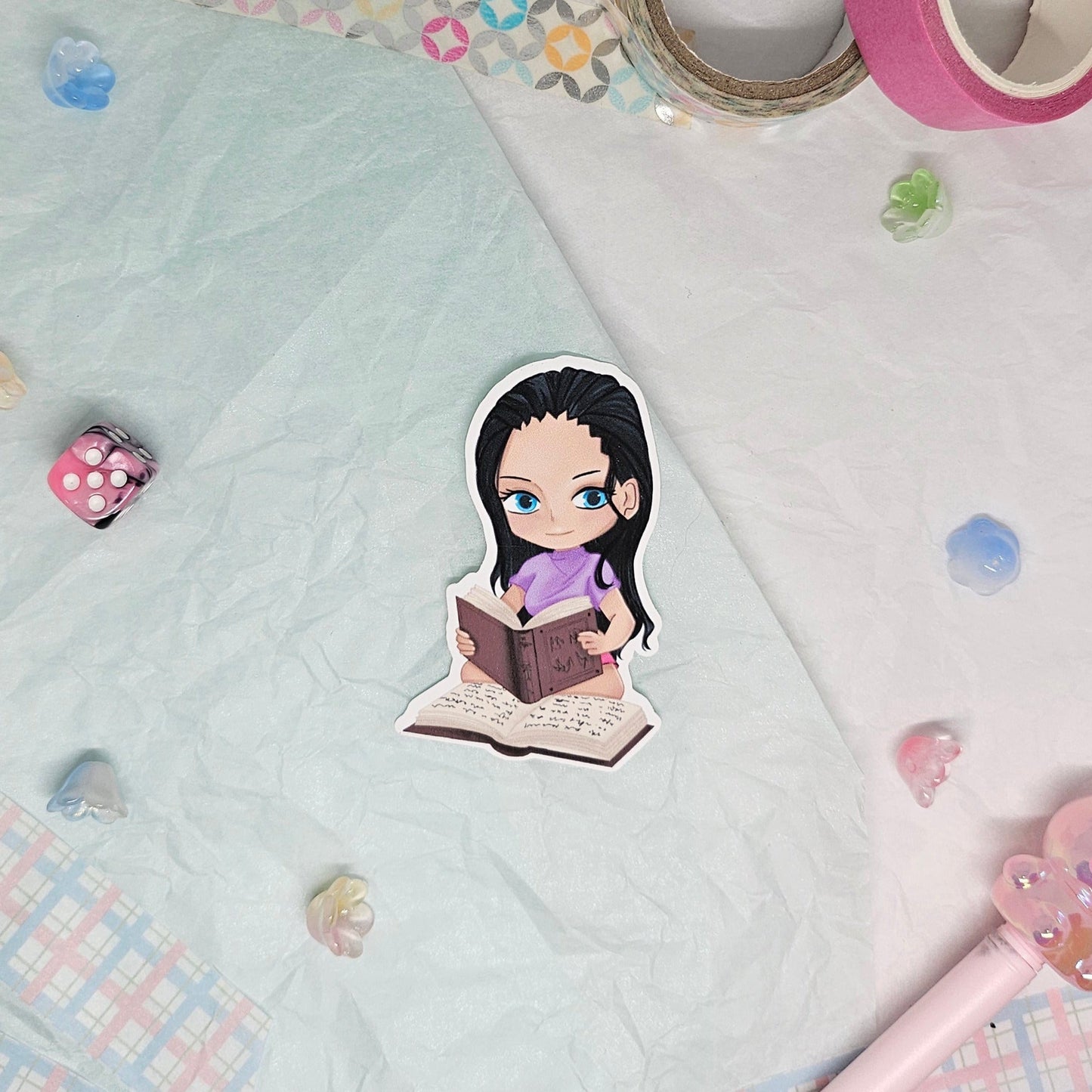 Sticker of Nico Robin from One Piece reading