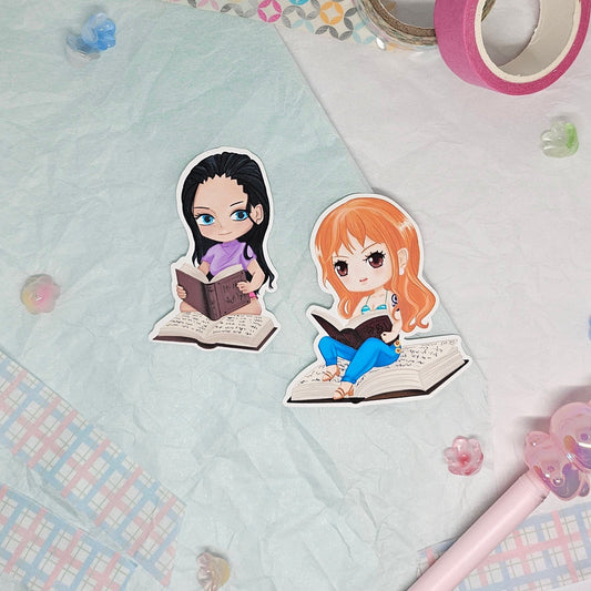 Stickers of Nami and Nico Robin from One Piece reading